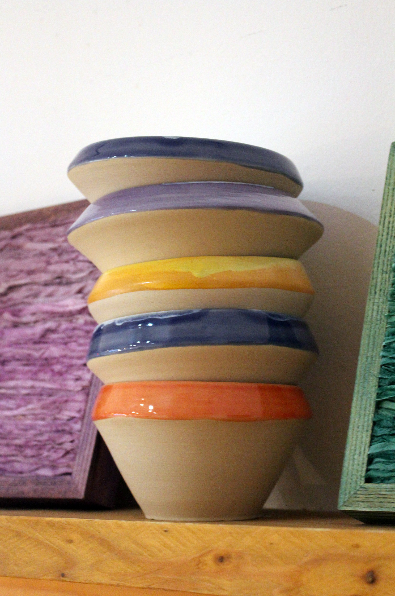 stack of colorued rim bowls, sigle fired, sustainable clay